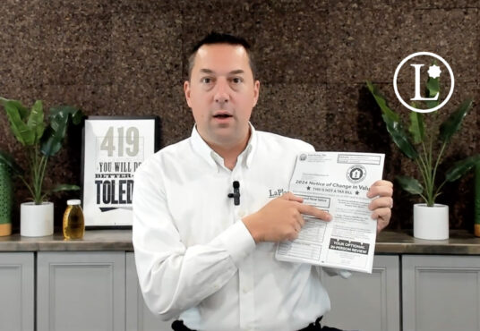 Andrew Fidler in white shirt in front of brown backdrop