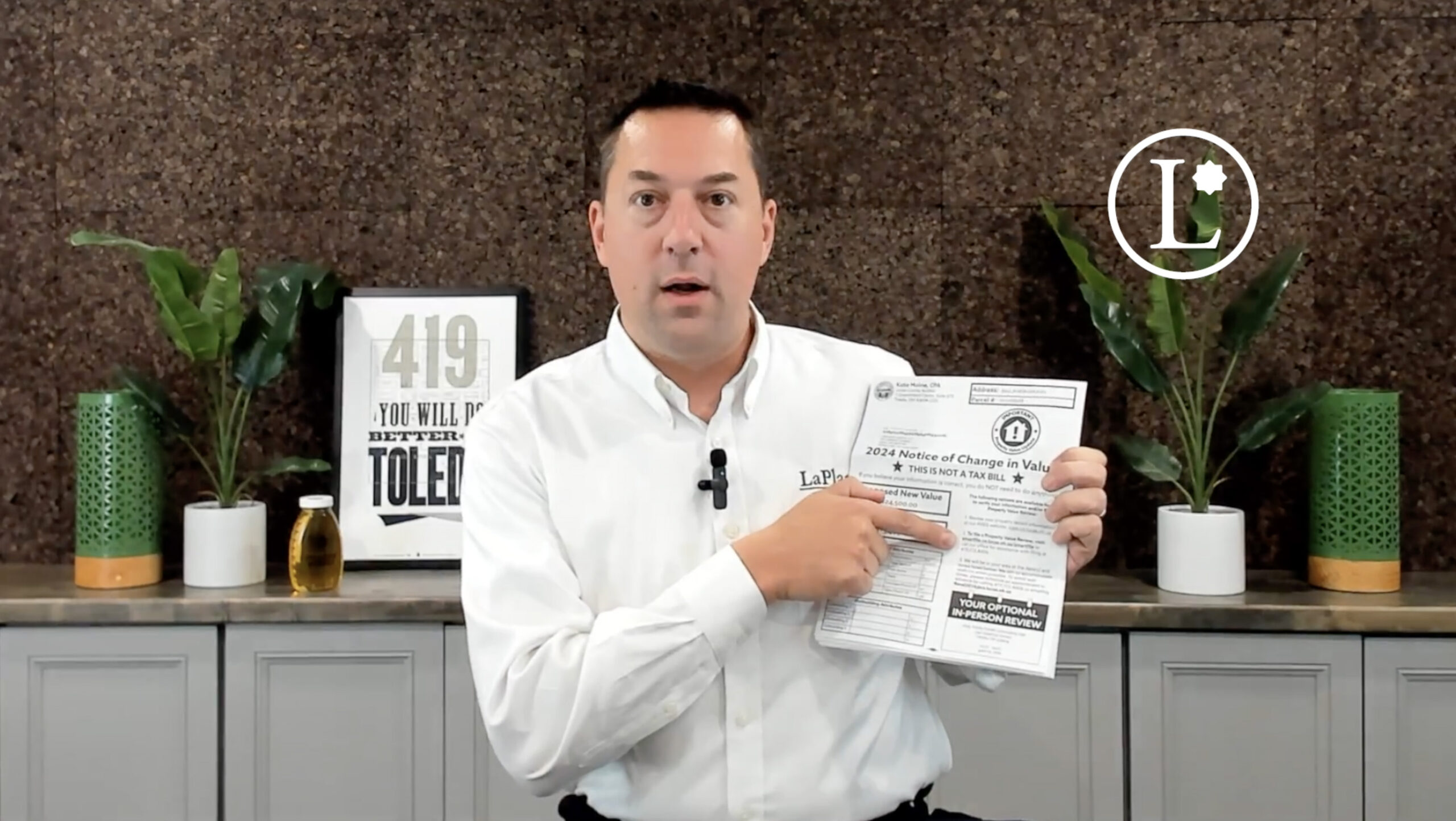 Andrew Fidler in white shirt in front of brown backdrop